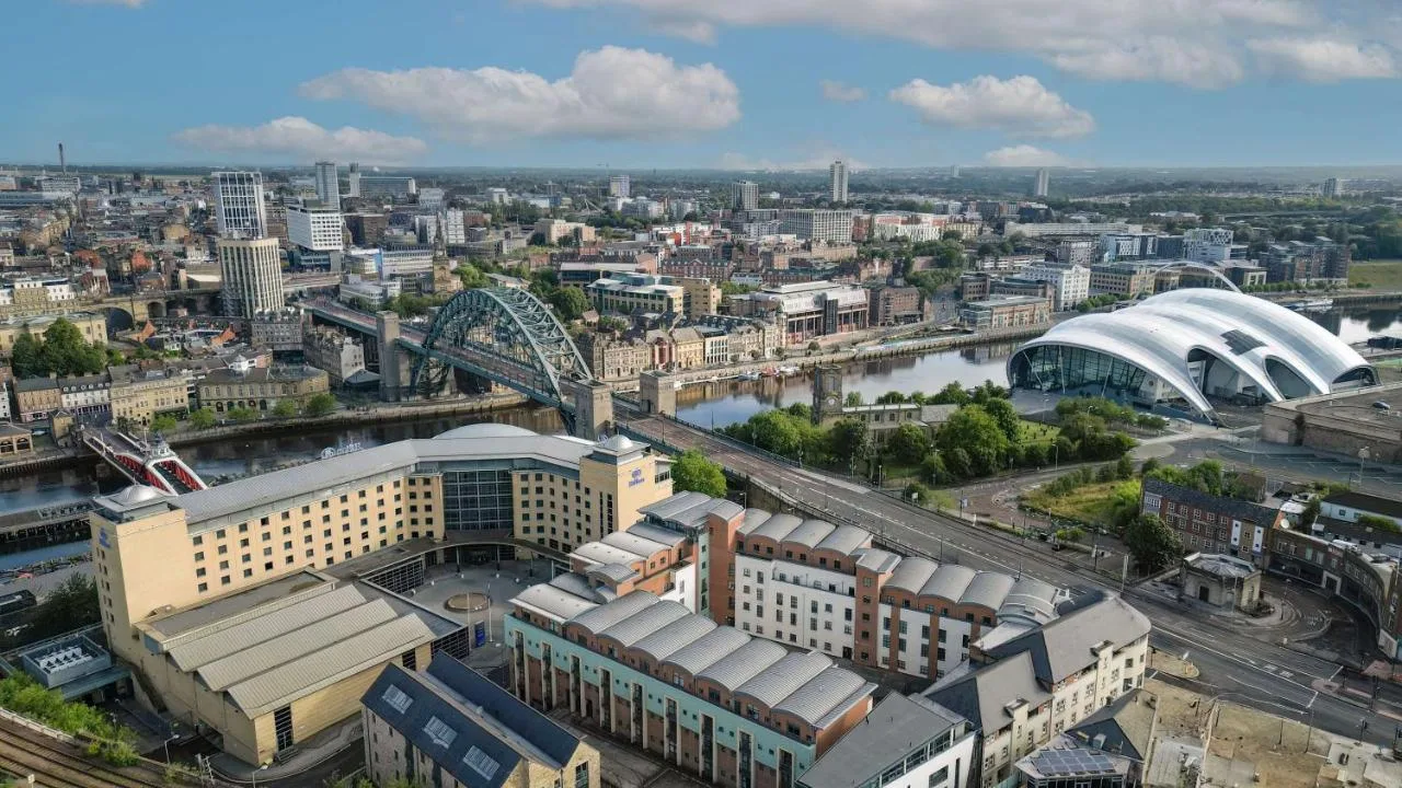 an aerial view of a city with a river and buildings at Hilton Newcastle Tyne Bridge in Newcastle upon Tyne