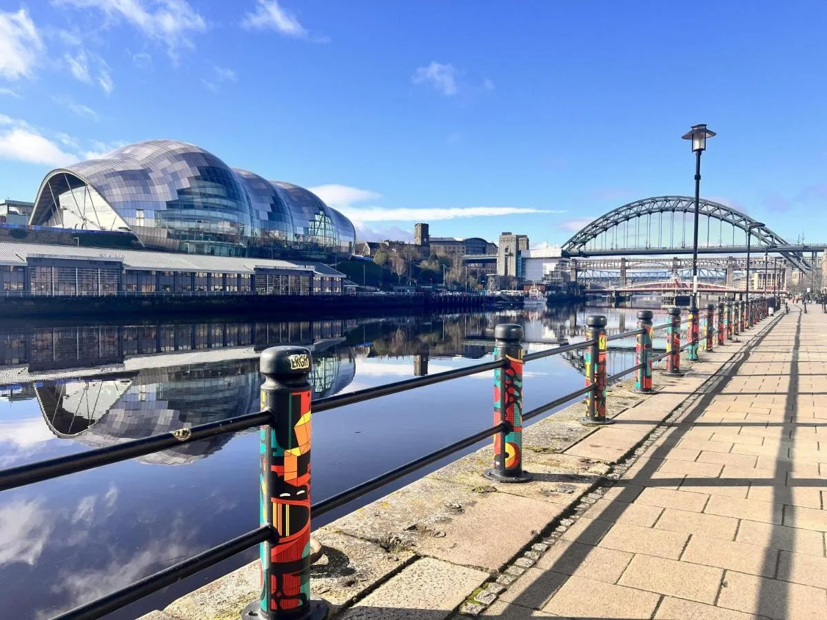 a view of a river with buildings and a bridge at Hilton Newcastle Tyne Bridge in Newcastle upon Tyne