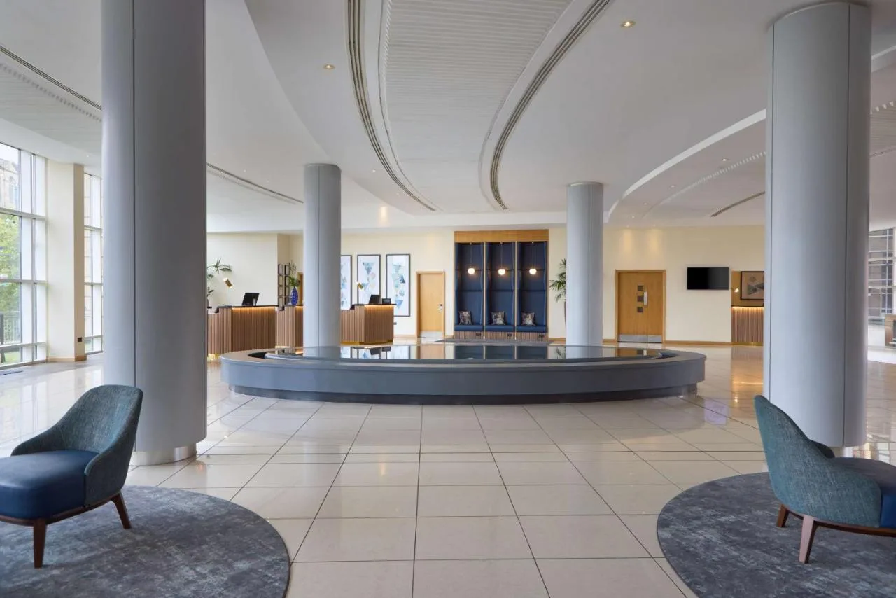 a lobby with two chairs and a waiting room at Hilton Newcastle Tyne Bridge in Newcastle upon Tyne