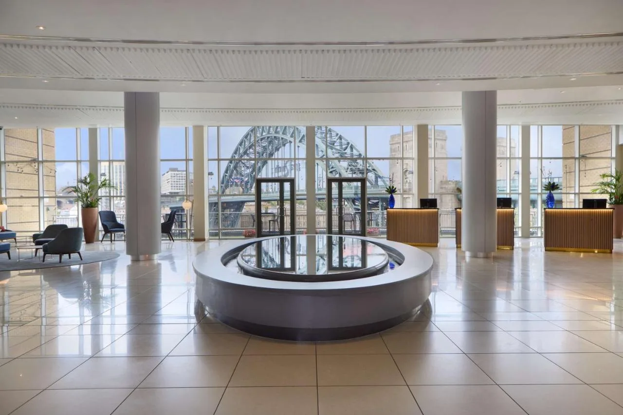 a large lobby with a large ferris wheel in the background at Hilton Newcastle Tyne Bridge in Newcastle upon Tyne